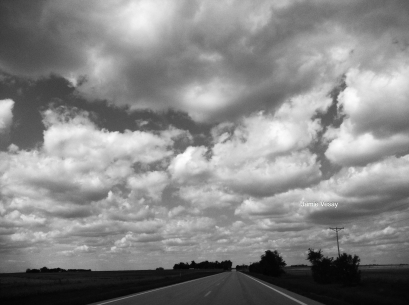 Summer clouds over a country road.